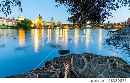 Vltava River and illuminated Charles Bridge at evening time. Prague, Czech Republic Vltava River and illuminated Charles Bridge at evening time. Prague, Czech Republic 68320875