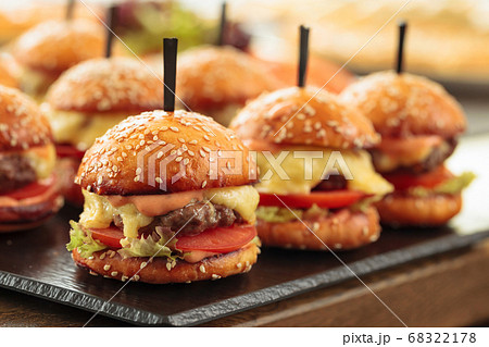 Burgers on wooden table in restaurant . Burgers on wooden table in restaurant . 68322178