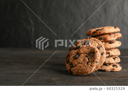 Stack of tasty chocolate chip cookies on wooden 68325329