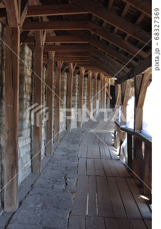 Arcade of wooden piles and beams. A long corridor 68327369