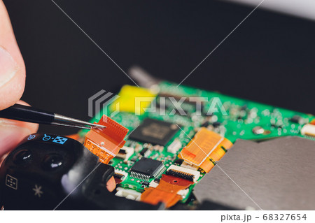 Engineer and technician Minitures are fixing camera mirror box assembly , Miniture workers are checking optics and carry out maintenance and cleaning of the broken camera at the service center. 68327654