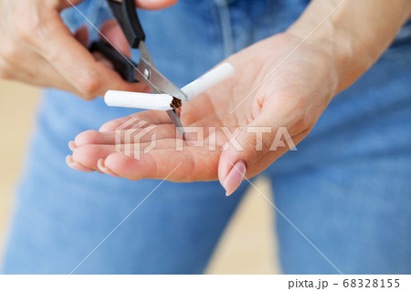 Stop smoking, young girl holding broken cigarette in hands. Stop smoking, young girl holding broken cigarette in hands. 68328155