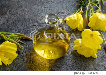 A bottle of evening primrose oil with blooming evening primrose 68328350