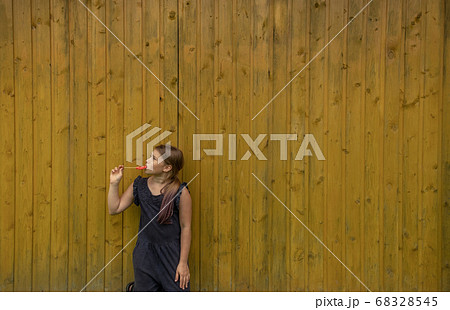 A cute young girl holding a lollipop A cute young girl holding a lollipop 68328545