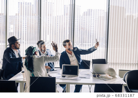Caucasian businessman taking selfie with his middle eastern and indian partners Caucasian businessman taking selfie with his middle eastern and indian partners 68331187