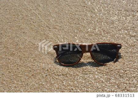 Dark Brown Sunglasses on Beach Sand in Greece Dark Brown Sunglasses on Beach Sand in Greece 68331513