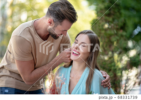 Bearded male hugging smiling female, showing his affection 68331739