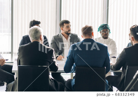 Corporate interracial business team with cheerful leader in a meeting, close up 68332349