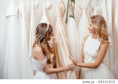 two caucasian girlfriends among wedding dresses two caucasian girlfriends among wedding dresses 68332910