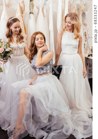 three caucasian brides with beautiful hair and makeup posing in salon three caucasian brides with beautiful hair and makeup posing in salon 68333247