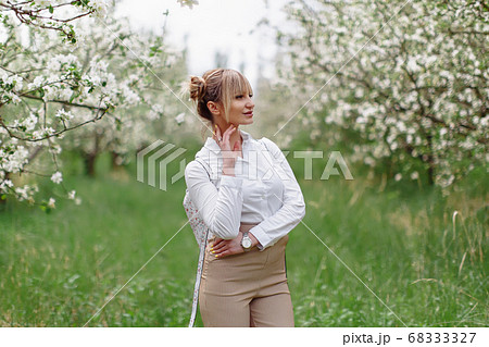 Beautiful young blonde woman in white shirt with 68333327