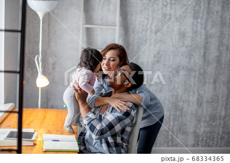 close up photo. happy mother and father having fun with their lovely kid 68334365