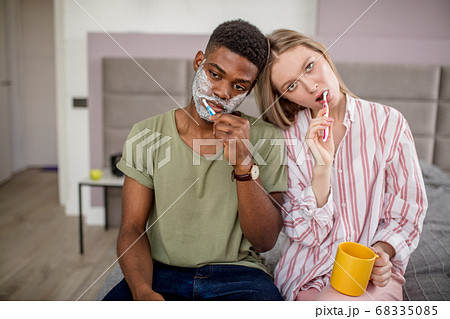 Couple washing teeth in morning, dental hygiene is important Couple washing teeth in morning, dental hygiene is important 68335085