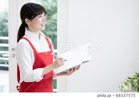 家事代行サービス　ファイルを持って点検する女性 68337575
