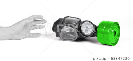 Arm reaching for vintage gasmask isolated on white 68347280