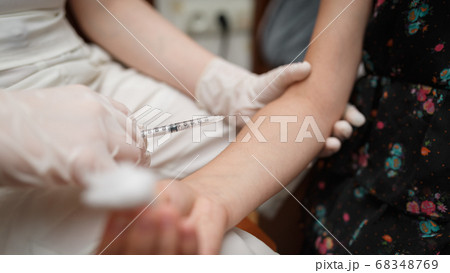 Vaccine injection into the hand of a little girl. Vaccine injection into the hand of a little girl. 68348769