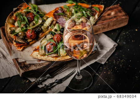 Glass of rose wine and pizza with mushrooms 68349034