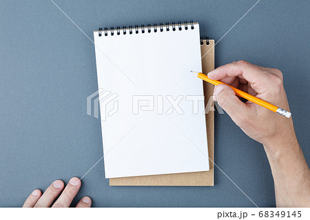 Notebook clear page and male hands with pencil. 68349145