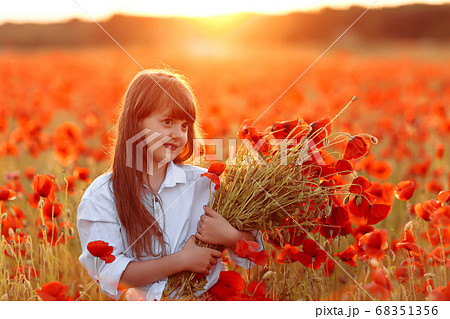 Cute little girl in white dress with a bouquet of Cute little girl in white dress with a bouquet of 68351356
