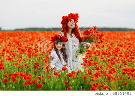 Little girl with redhead mother in white dresses Little girl with redhead mother in white dresses 68351403