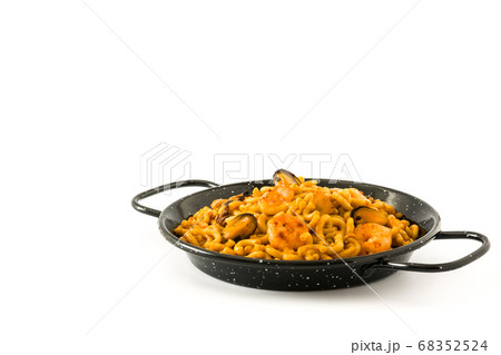 Traditional Spanish fideua. Noodle paella isolated on white background. Traditional Spanish fideua. Noodle paella isolated on white background. 68352524