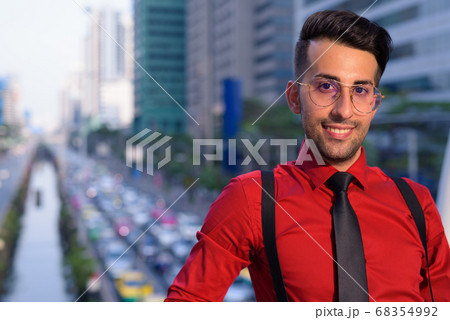 Young handsome Persian businessman exploring the city Young handsome Persian businessman exploring the city 68354992