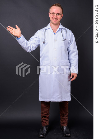 Portrait of happy handsome man doctor with blond hair 68355321
