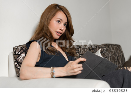 Happy young beautiful Asian woman in the living room at home 68356323