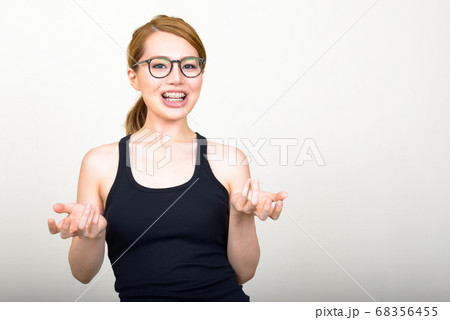Portrait of happy young beautiful Asian woman 68356455