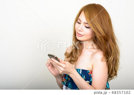 Portrait of young beautiful Asian woman using phone Portrait of young beautiful Asian woman using phone 68357102