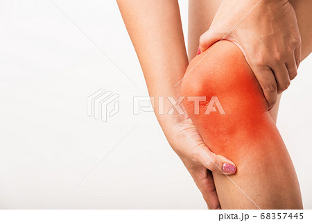 Woman holding her painful knee 68357445