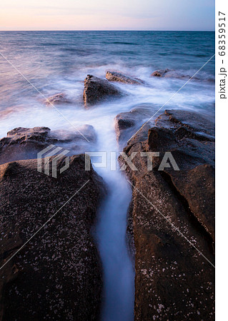Waves and rocks shore long exposure 68359517