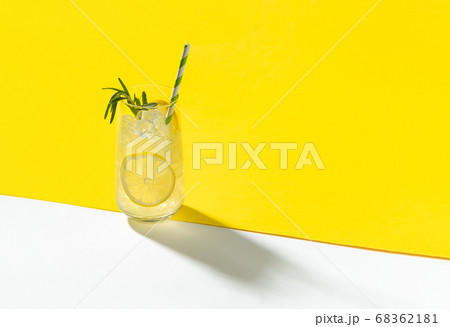 Glass ice lemonade with rosemary on yellow 68362181