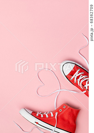 Minimal composition with red sneakers on pink Minimal composition with red sneakers on pink 68362709