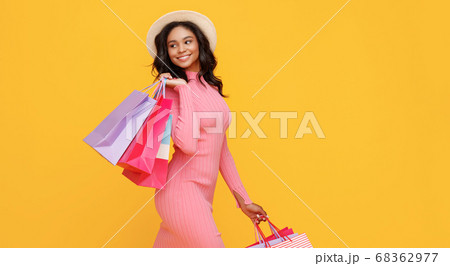 Happy ethnic shopper with paper bags Happy ethnic shopper with paper bags 68362977