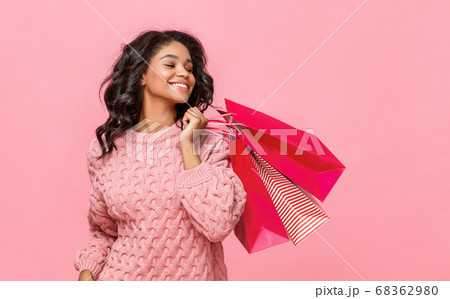 Friendly ethnic shopper with paper bags. 68362980