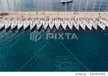 Aerial panoramic view of city Komiza - the one of numerous port towns in Croatia, is a lot of moored sailboats of a regatta 68364080