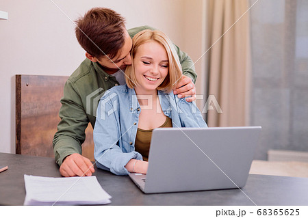 lovely cute couple sit together on table at home 68365625