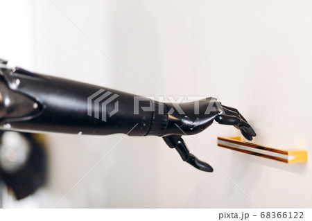 prosthetic black arm holding a handle prosthetic black arm holding a handle 68366122