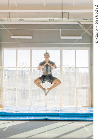 active sportsman performs lotus posture 68366232