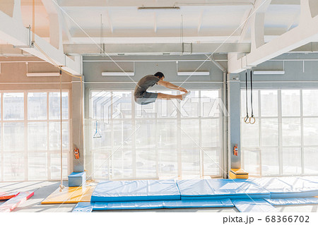 flexible gymnast is doing some exercises on the air flexible gymnast is doing some exercises on the air 68366702