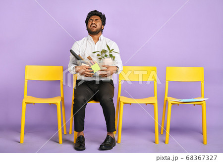 frustrated young dark-skinned man quit job 68367327
