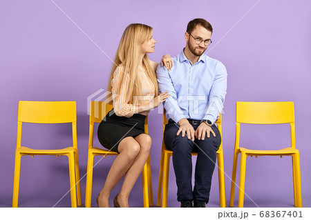 young female coworker comforting and supporting sad male coworker young female coworker comforting and supporting sad male coworker 68367401
