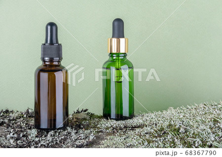 Two brown, green glass bottles with serum, 68367790