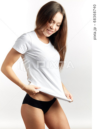 Sexy brown woman in white T-shirt and black pants Sexy brown woman in white T-shirt and black pants 68368740