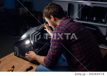awesome happy man enjoying working with broken computers awesome happy man enjoying working with broken computers 68369478
