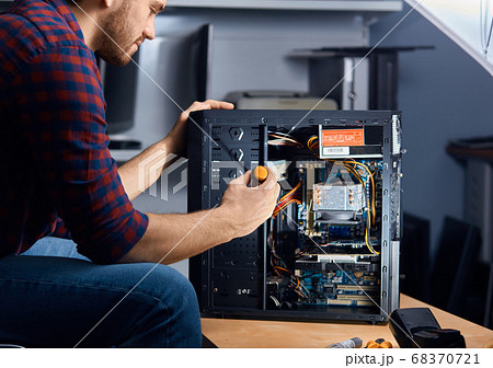 specialised computer repair technician testing an old system unit specialised computer repair technician testing an old system unit 68370721
