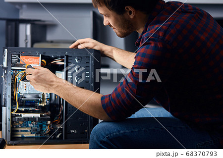 man disassembling and reassemblin the computer man disassembling and reassemblin the computer 68370793