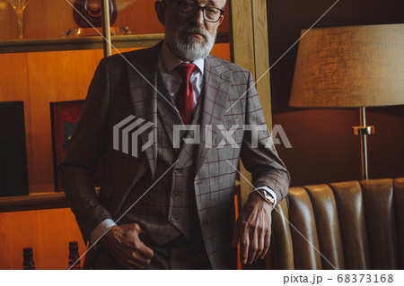 Toned retro styled portrait of businessman sitting in armchair at office Toned retro styled portrait of businessman sitting in armchair at office 68373168