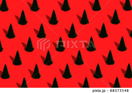 Pattern from Christmas trees on red background 68373548